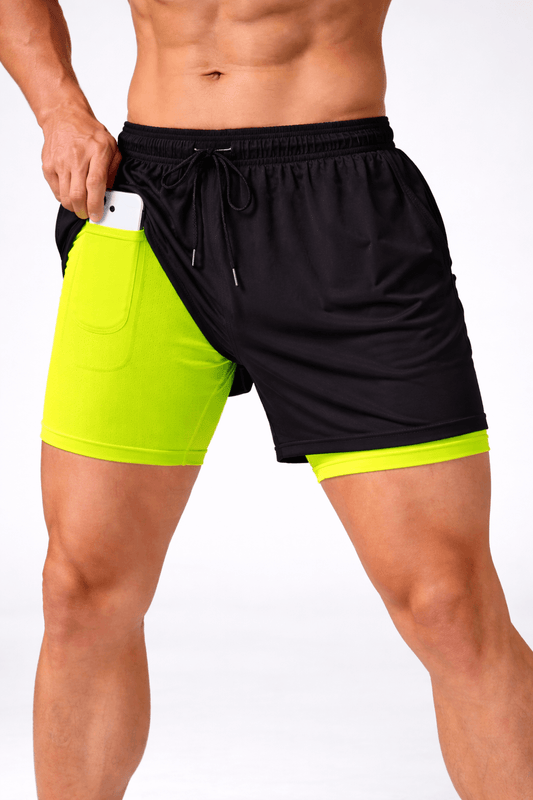 Model wearing WF-PS01 black and vibrant green activewear shorts with a phone in the pocket.